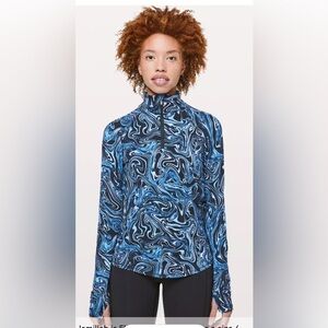 Lululemon Suminagashi Run 1/2 Zip top in the "Serene Blue" pattern.